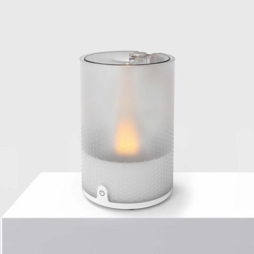 VOTIV4 on a white pedestal displaying tranquil flameless candlelight